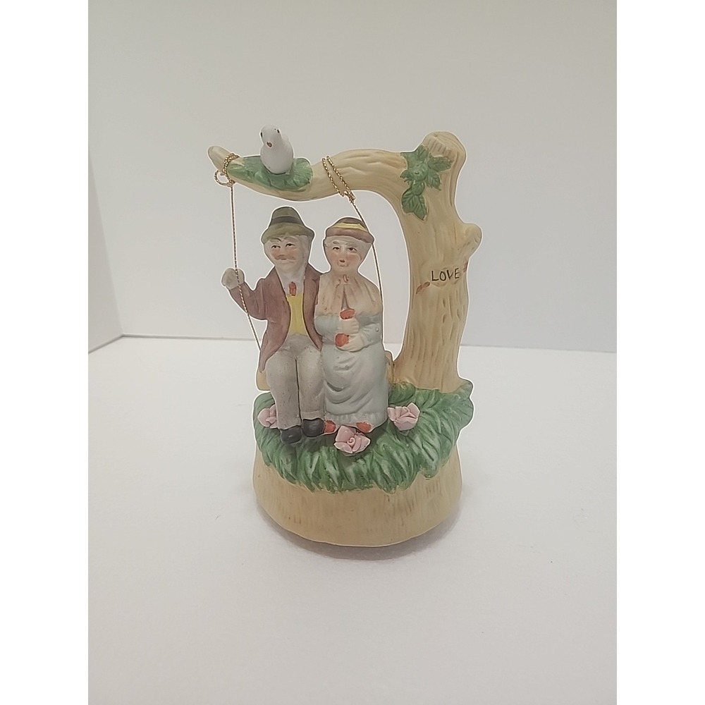 MSR Imports Inc. Porcelain Music Box Elderly Couple on Swing. Writing On Bottom